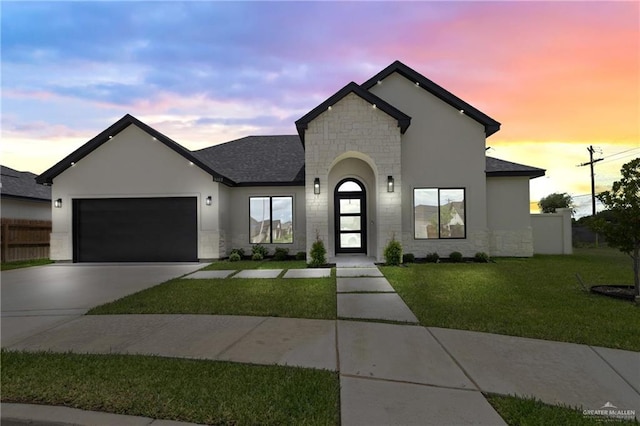5112 W Burberry St, Edinburg, TX 78541 - french country inspired facade featuring stone siding, driveway, an attached garage, and stucco siding