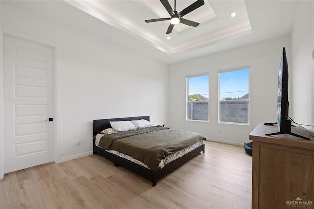 5112 W Burberry St, Edinburg, TX 78541 - bedroom featuring light wood-type flooring, a tray ceiling, recessed lighting, and ceiling fan