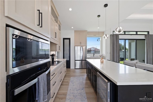5112 W Burberry St, Edinburg, TX 78541 - kitchen with stainless steel appliances, light wood-style floors, a large island, wine cooler, and light countertops