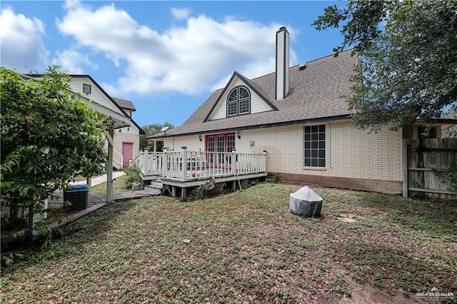 rear view of property featuring a wooden deck