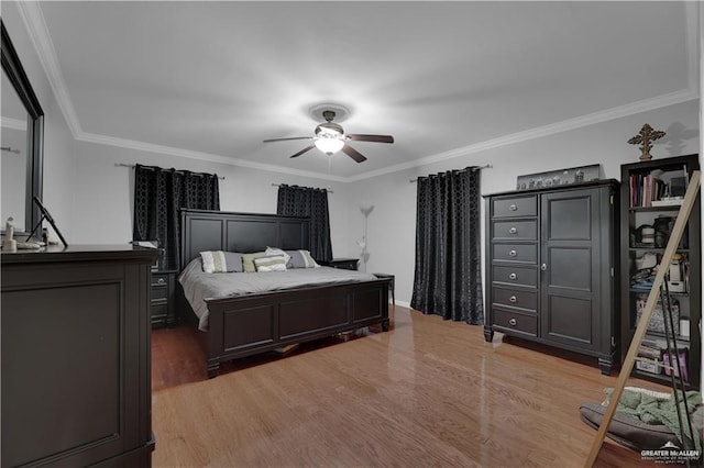 bedroom with ceiling fan, dark hardwood / wood-style floors, and ornamental molding