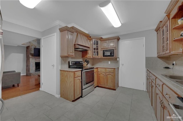 kitchen featuring light brown cabinetry, stainless steel range with electric stovetop, custom exhaust hood, black microwave, and crown molding