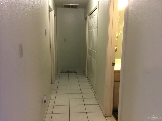 hallway featuring light tile patterned flooring