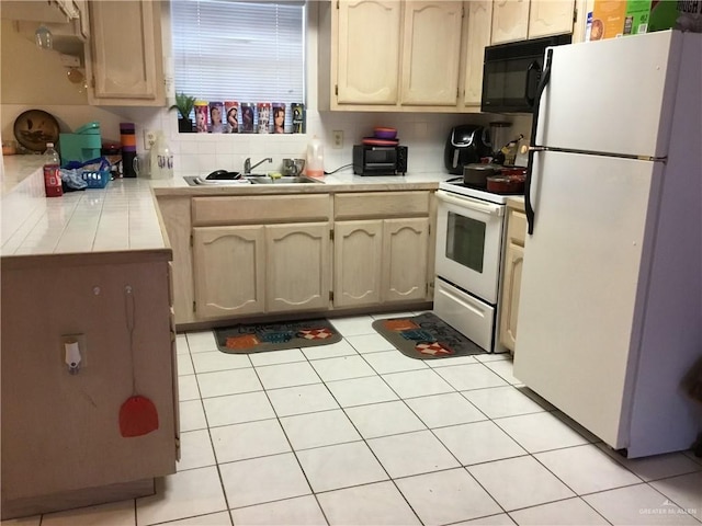 kitchen with decorative backsplash, white appliances, sink, and light tile patterned floors