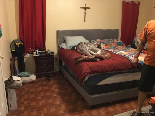 bedroom featuring dark parquet floors