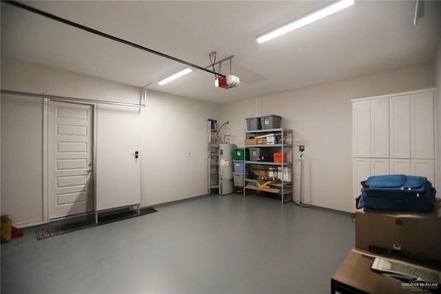 garage featuring electric water heater and a garage door opener