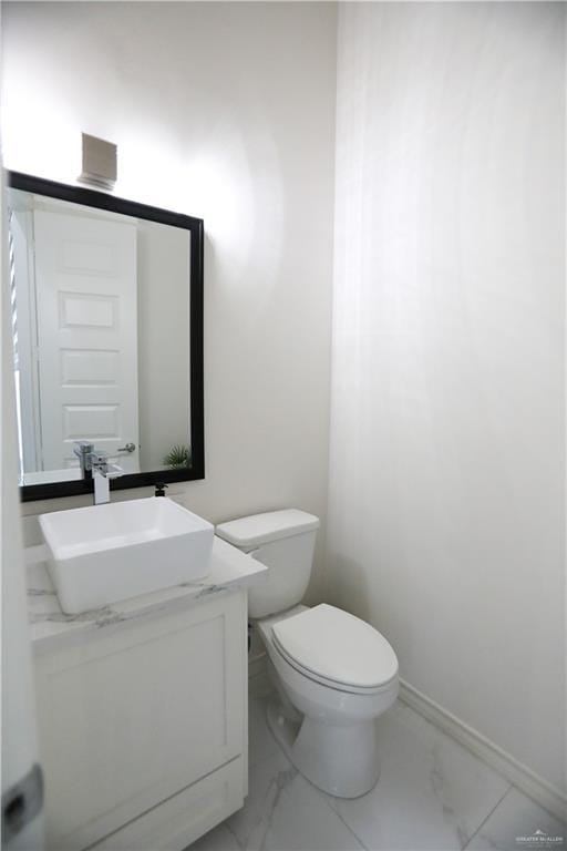 bathroom featuring toilet and vanity