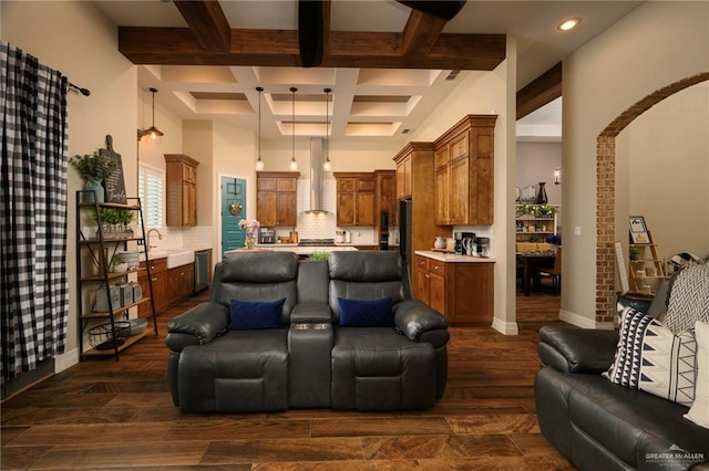 home theater featuring beamed ceiling, sink, dark wood-type flooring, and coffered ceiling