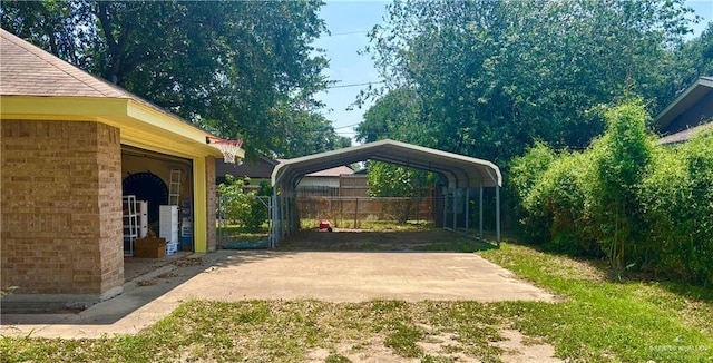 view of yard with a detached carport and fence