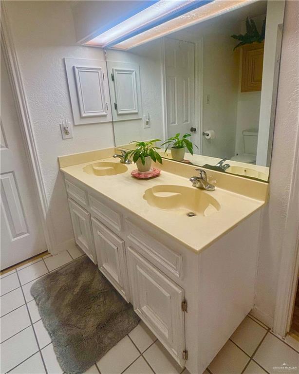 full bathroom with a sink and tile patterned floors