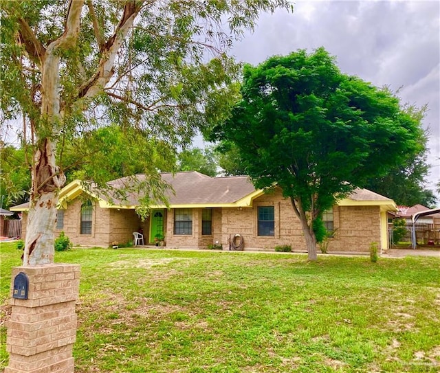 single story home with fence and a front yard