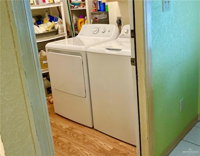 washroom featuring laundry area and separate washer and dryer