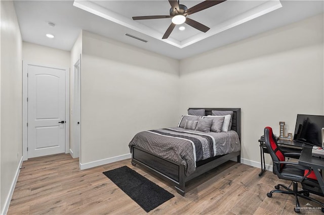 1620 Stonegate Dr, Mission, TX 78574 - bedroom with a tray ceiling, light wood-type flooring, baseboards, an office area, and recessed lighting