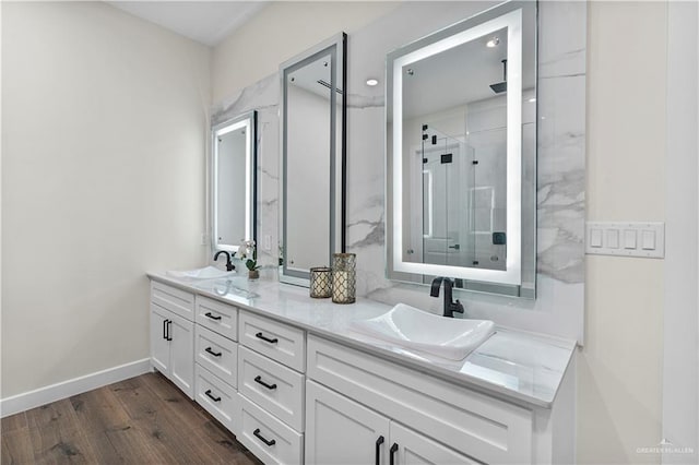 1620 Stonegate Dr, Mission, TX 78574 - full bath featuring a shower stall, wood finished floors, double vanity, and baseboards