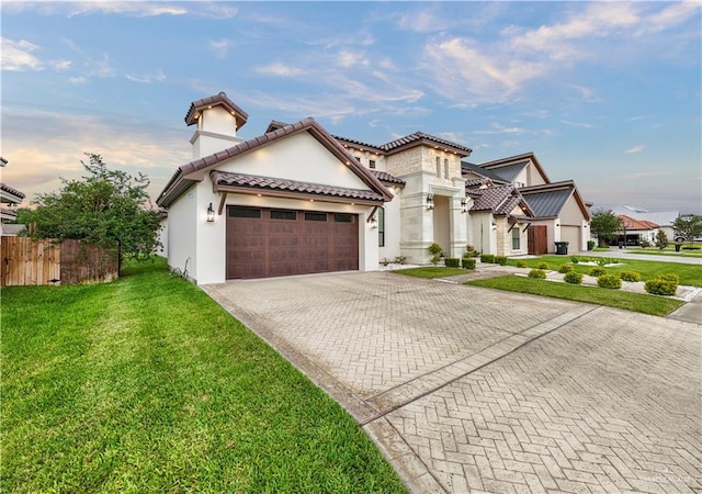 1620 Stonegate Dr, Mission, TX 78574 - mediterranean / spanish house with an attached garage, decorative driveway, stucco siding, a tile roof, and a chimney