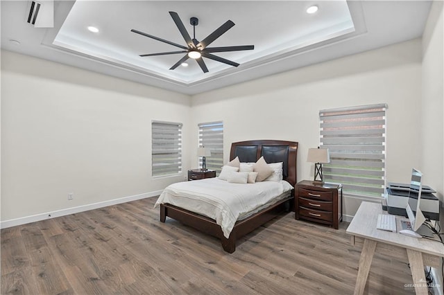 1620 Stonegate Dr, Mission, TX 78574 - bedroom with a tray ceiling, wood finished floors, baseboards, recessed lighting, and an office area