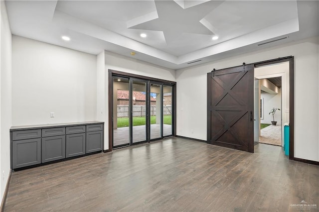 1620 Stonegate Dr, Mission, TX 78574 - spare room featuring a raised ceiling, baseboards, wood finished floors, a barn door, and recessed lighting