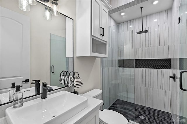 1620 Stonegate Dr, Mission, TX 78574 - bathroom featuring toilet, a shower stall, and vanity