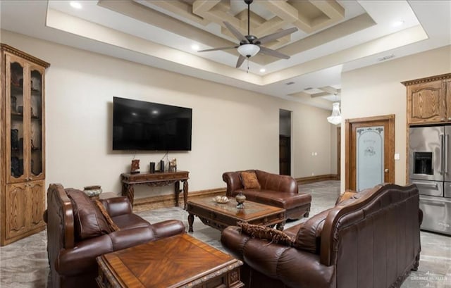 living room with light carpet, a tray ceiling, and ceiling fan