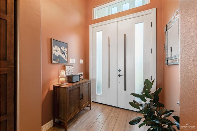 entryway with light hardwood / wood-style floors and a wealth of natural light