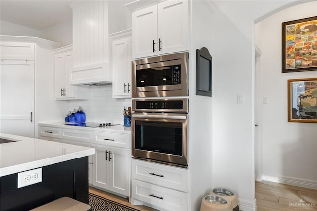 kitchen featuring light hardwood / wood-style floors, white cabinetry, and appliances with stainless steel finishes