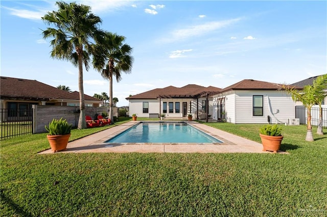 view of swimming pool with a lawn