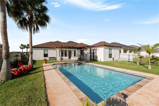 view of pool featuring a lawn