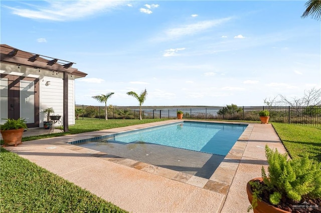 view of pool with a lawn and a patio area