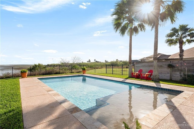 view of pool with a yard