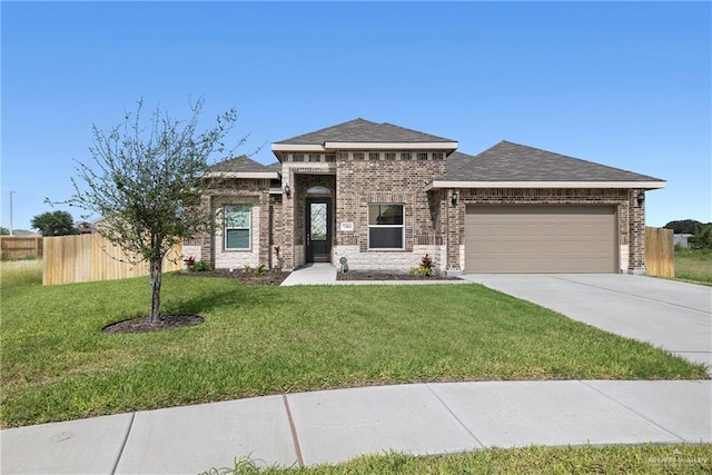 7303 Umar Ave, Mission, TX 78573 - prairie-style home featuring an attached garage, concrete driveway, and brick siding