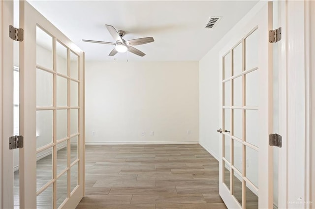 7303 Umar Ave, Mission, TX 78573 - empty room with a ceiling fan, french doors, wood finished floors, and baseboards