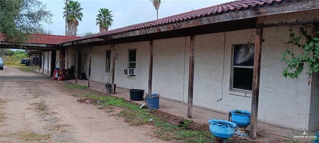 5906 N Brushline Rd, Mission, TX 78574 - view of property exterior featuring a tile roof and cooling unit