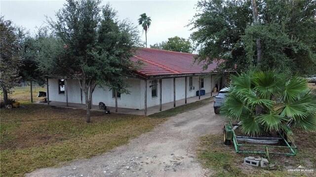 5906 N Brushline Rd, Mission, TX 78574 - view of front of property featuring dirt driveway and stucco siding