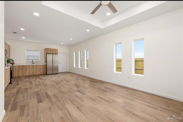 interior space featuring light hardwood / wood-style floors, ceiling fan, and sink