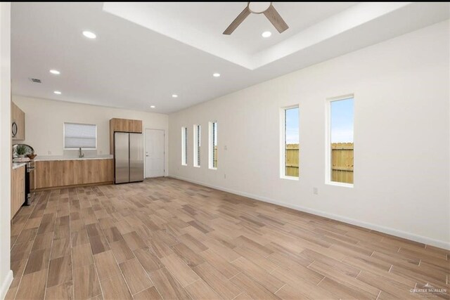2913 E Israel Ave, Alton, TX 78573 - unfurnished living room with ceiling fan, light wood finished floors, recessed lighting, a sink, and baseboards