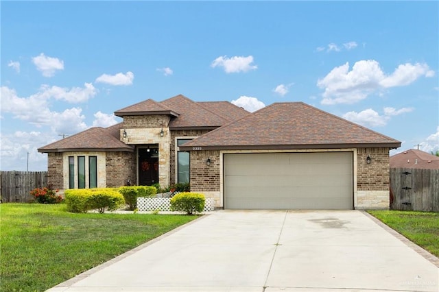 view of front of house featuring a garage and a front lawn