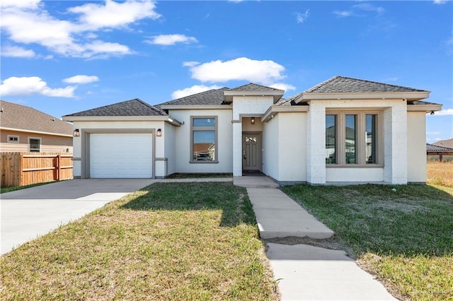 view of front of property featuring a garage and a front lawn