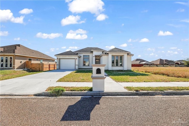 view of front of property with a garage and a front yard