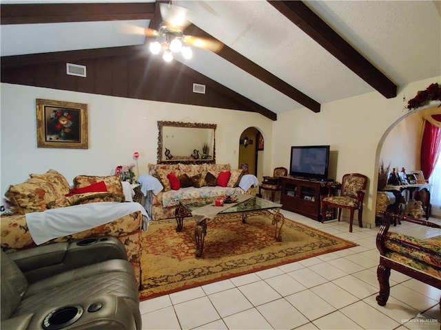 living room featuring vaulted ceiling with beams, ceiling fan, and light tile patterned flooring