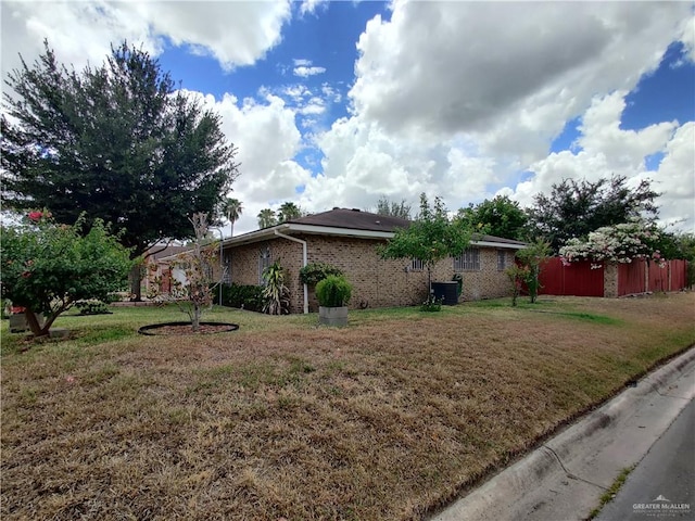 view of home's exterior with central air condition unit and a yard