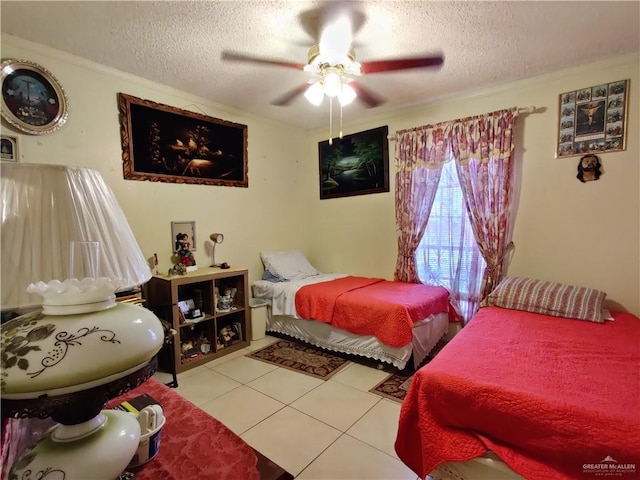 tiled bedroom featuring ceiling fan and a textured ceiling