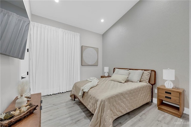 bedroom with light wood-type flooring, vaulted ceiling, and recessed lighting