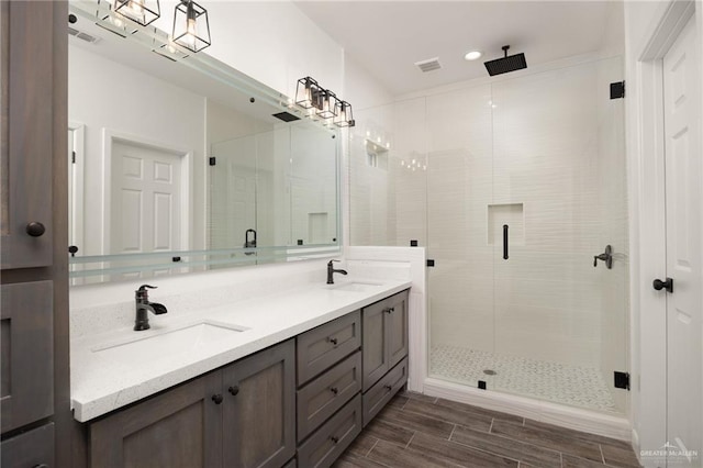 bathroom featuring vanity and a shower with door