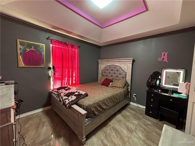 16400 Mcalister Ave, Edinburg, TX 78541 - bedroom featuring a tray ceiling and baseboards