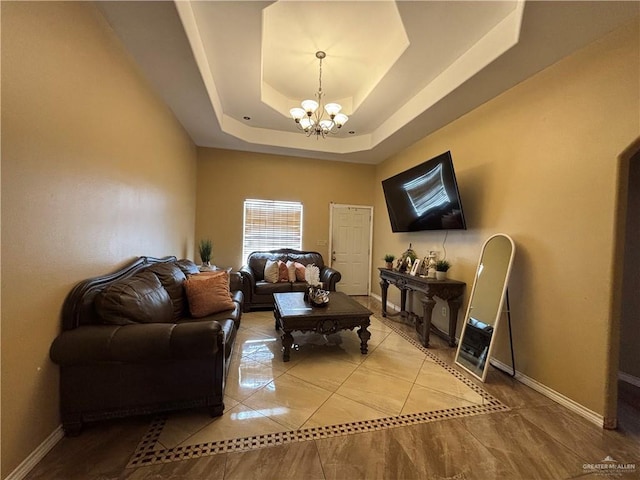 16400 Mcalister Ave, Edinburg, TX 78541 - living area with a chandelier, a tray ceiling, baseboards, and light tile patterned flooring