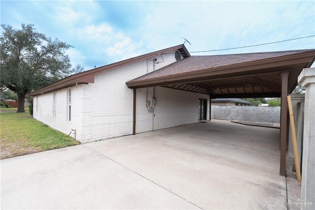 exterior space featuring a lawn and a carport