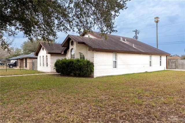 view of side of property with a lawn