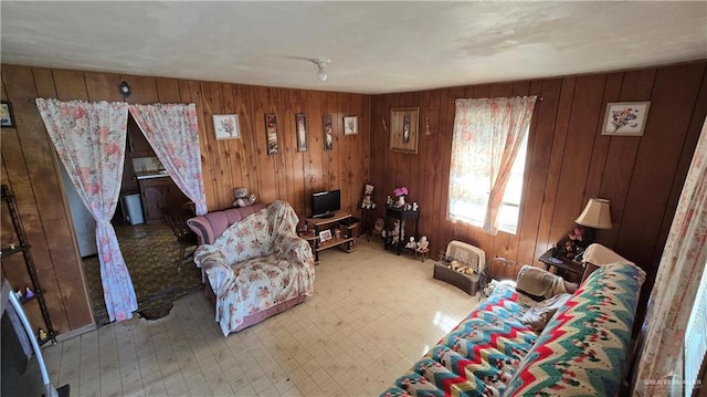 unfurnished living room with wood walls