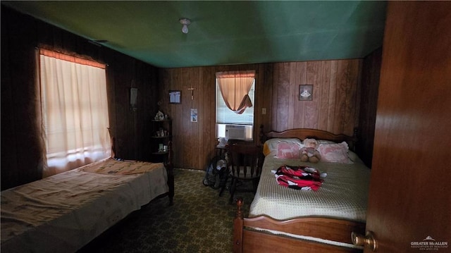 bedroom featuring wood walls and cooling unit