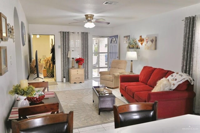 tiled living room featuring ceiling fan